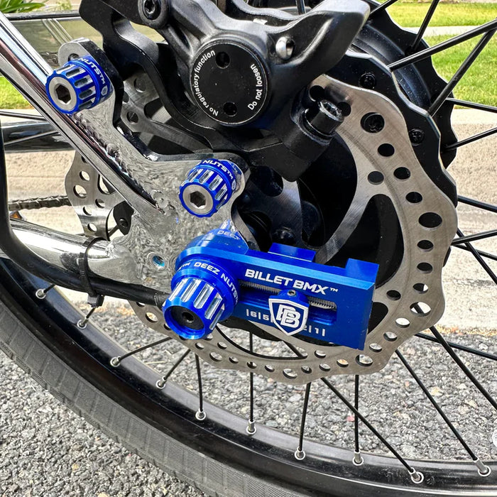 side view of billet bmx chain tensioner in blue