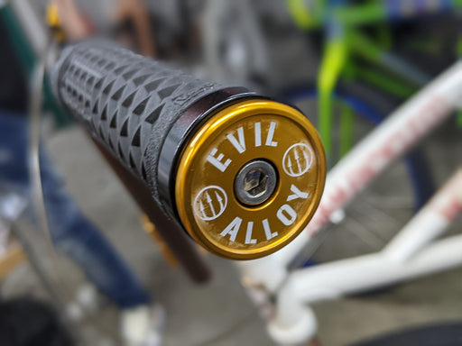 front view of evil alloy bar end in gold
